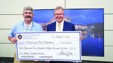 Picture This: Treasurer Pack presents firearms auction proceeds to Parkersburg Police Department
